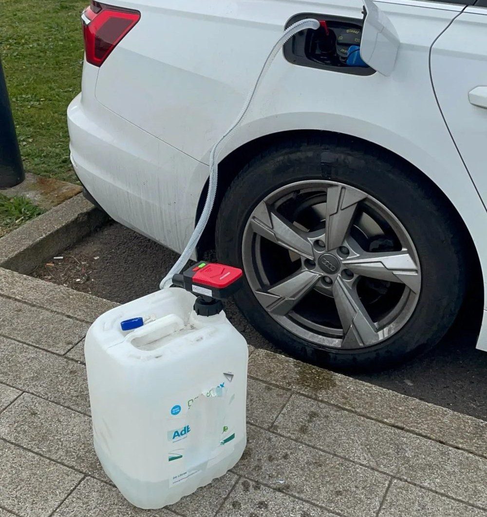 Customer photo: fuel can on the ground filling a car